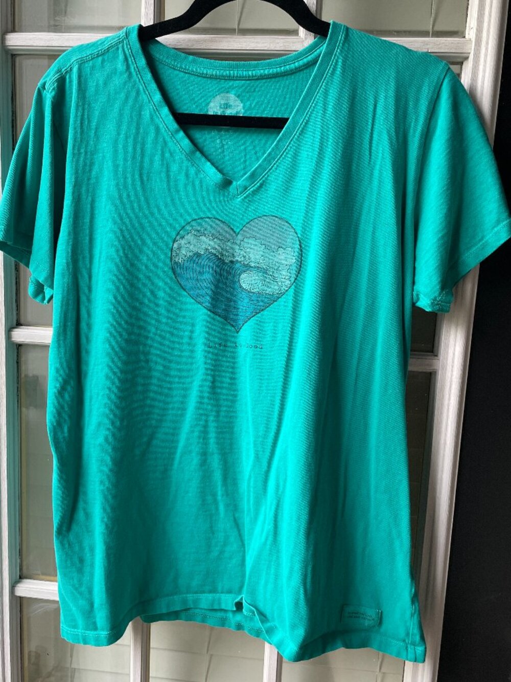 Life is Good Heart Crusher tee features a graphic of a wave inside a heart
